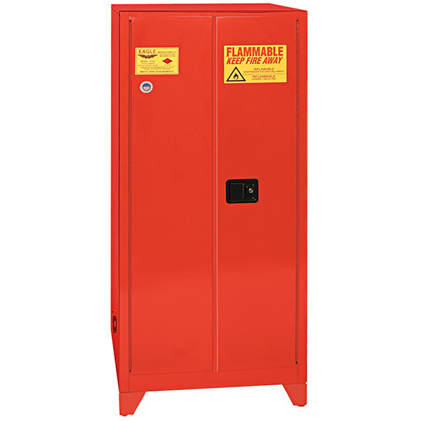 A red metal Eagle safety cabinet with a black handle and yellow and red warning sign.