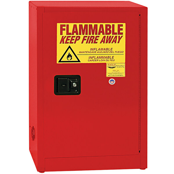 A red Eagle Manufacturing safety cabinet for flammable liquids with a yellow and black sign.
