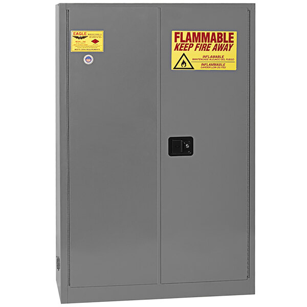 A gray metal Eagle safety cabinet with yellow and red warning signs.