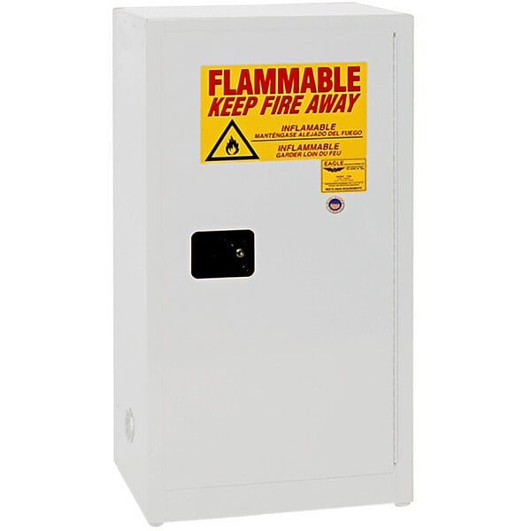 A white metal safety cabinet with a yellow sign reading "Flammable Liquid" and red text.