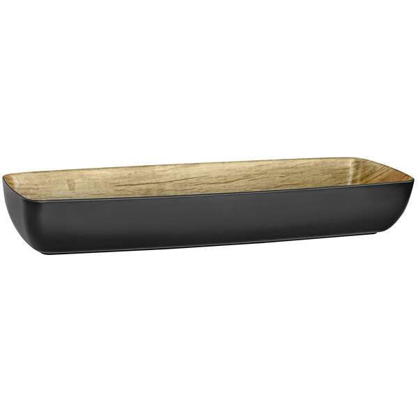 A rectangular black melamine bowl with a wooden surface.