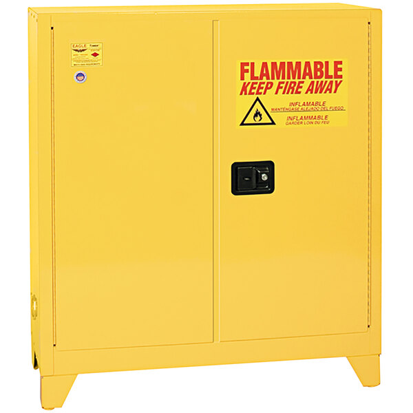 A yellow Eagle Manufacturing safety cabinet with a flammable sign.