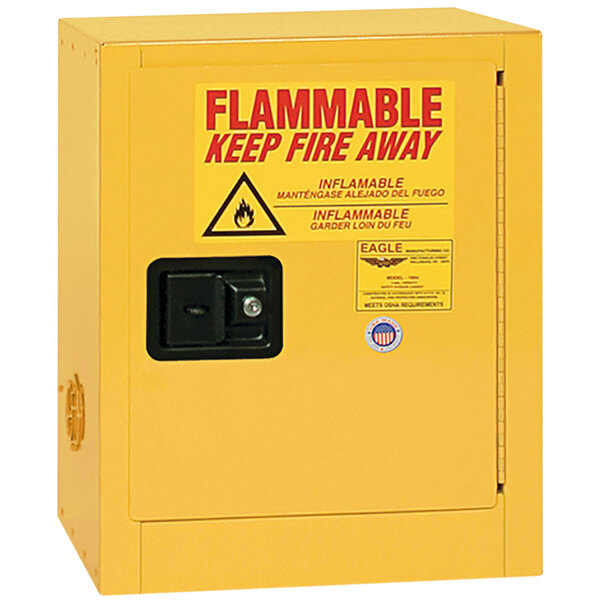 A yellow Eagle Manufacturing flammable liquid safety cabinet with a red and black sign on it.