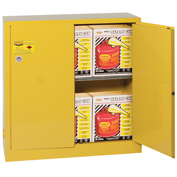 A yellow Eagle Manufacturing safety cabinet with two self-closing doors containing yellow safety cans.