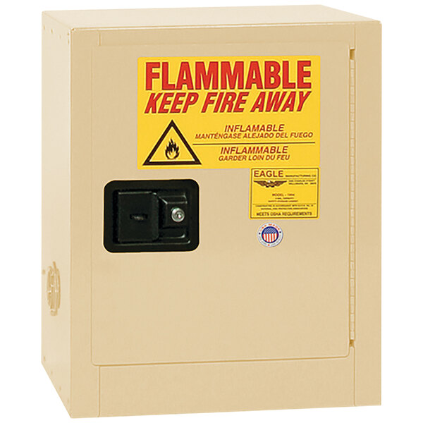 A beige Eagle Manufacturing safety cabinet with a yellow sign reading "Flammable" and "Self-Closing Door"