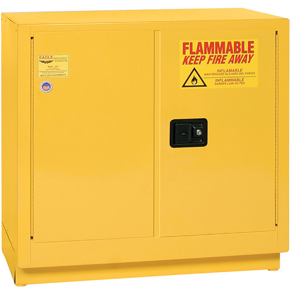 A yellow metal Eagle Manufacturing safety cabinet with red "Flammable" text.
