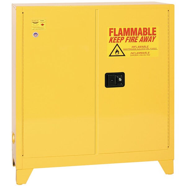 A yellow metal safety cabinet with red "Flammable" text.