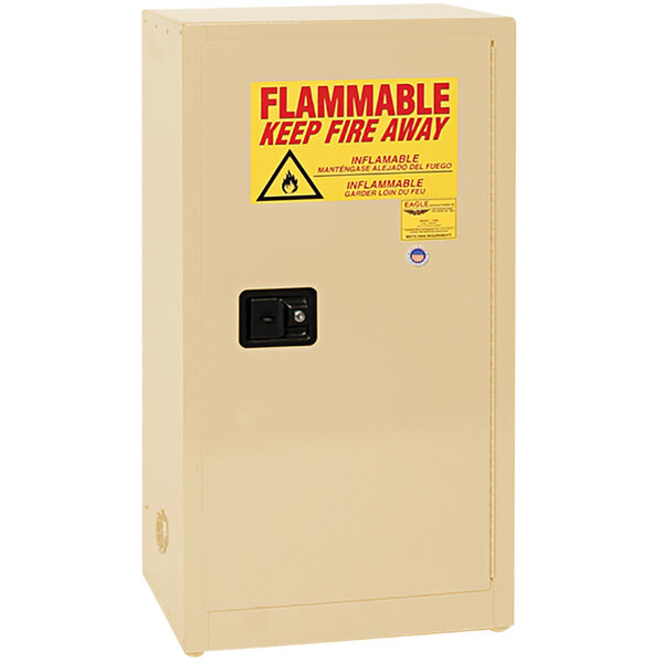 A beige safety cabinet with a yellow sign reading "flammable" and a black switch.