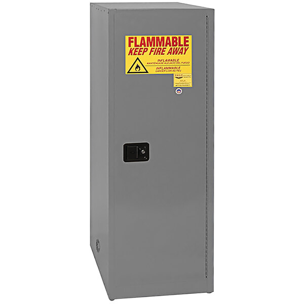 A grey Eagle Manufacturing safety cabinet for flammable liquids with a yellow flammable label.