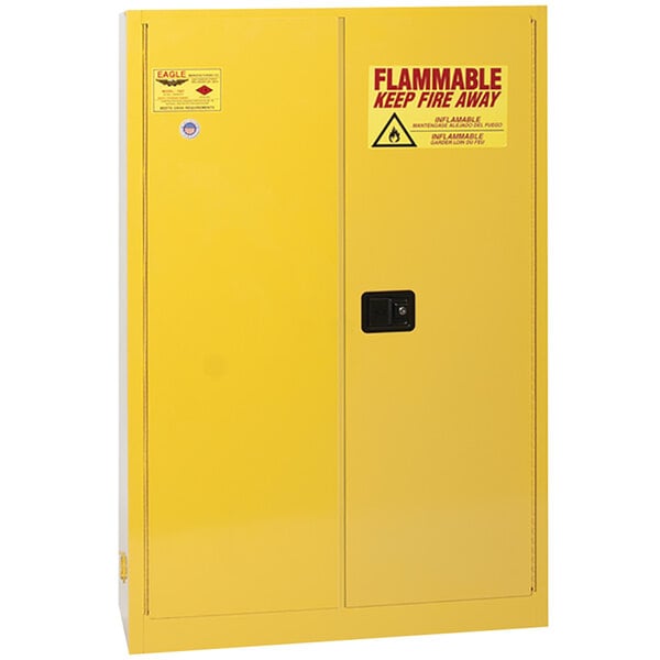A yellow Eagle Manufacturing safety cabinet with black handles and a warning sign.