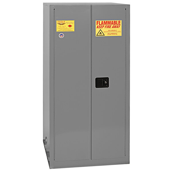 A grey steel Eagle safety cabinet with yellow labels.