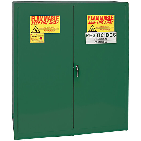 A green Eagle Manufacturing pesticide safety cabinet with yellow and red signs.