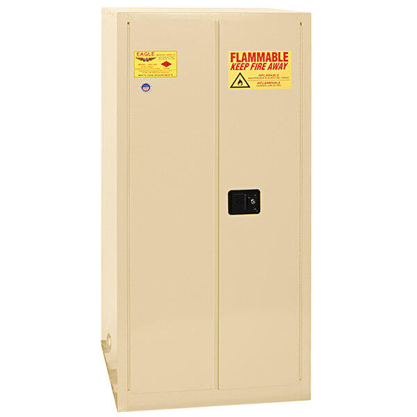 A beige Eagle Manufacturing safety cabinet with a white door and yellow labels.