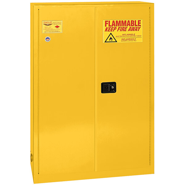 A yellow metal Eagle Manufacturing safety cabinet with a warning sign.