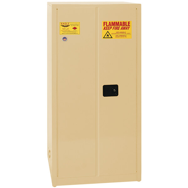 A white metal Eagle Manufacturing safety cabinet with 2 beige self-closing doors and yellow labels.