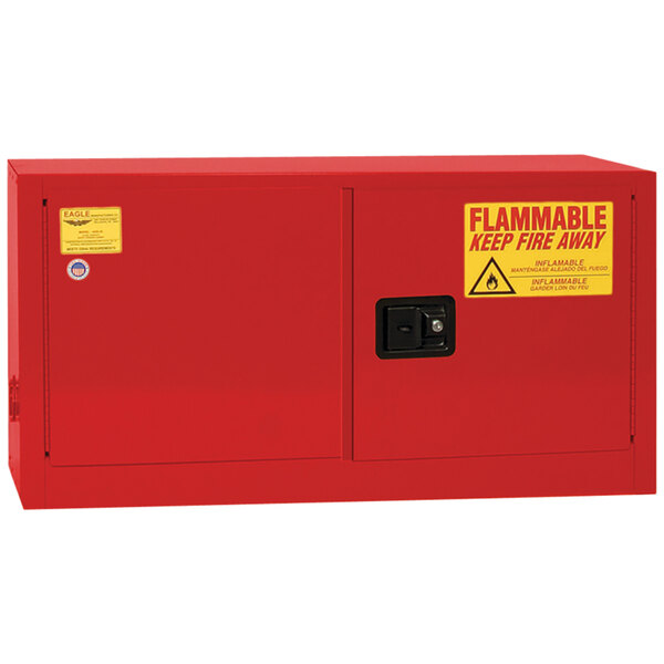 A red Eagle Manufacturing safety cabinet for flammable liquids with yellow warning label.