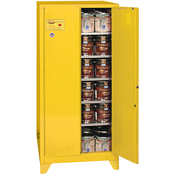A yellow Eagle safety cabinet with open doors holding cans of paint.
