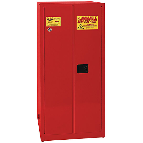 A red metal Eagle safety cabinet with yellow labels.