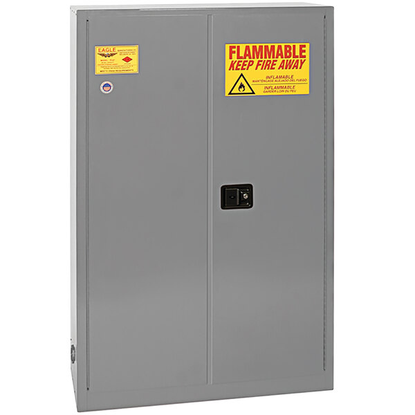 A grey Eagle Manufacturing safety cabinet with yellow and red warning signs.