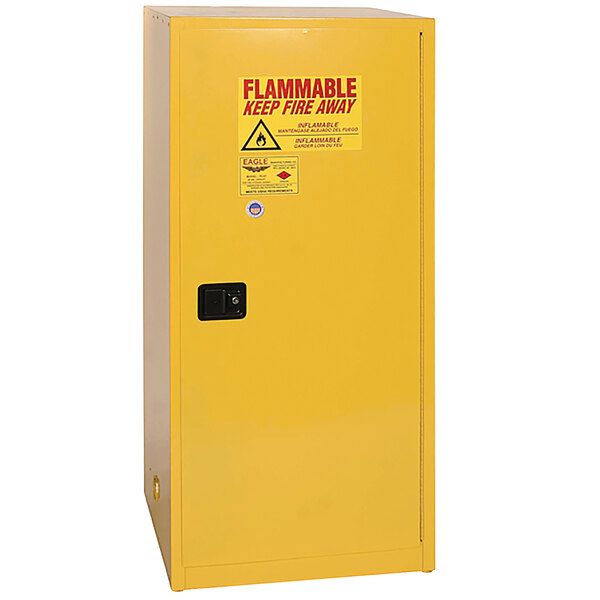 A yellow metal Eagle Manufacturing safety cabinet for flammable liquids with a red warning label.