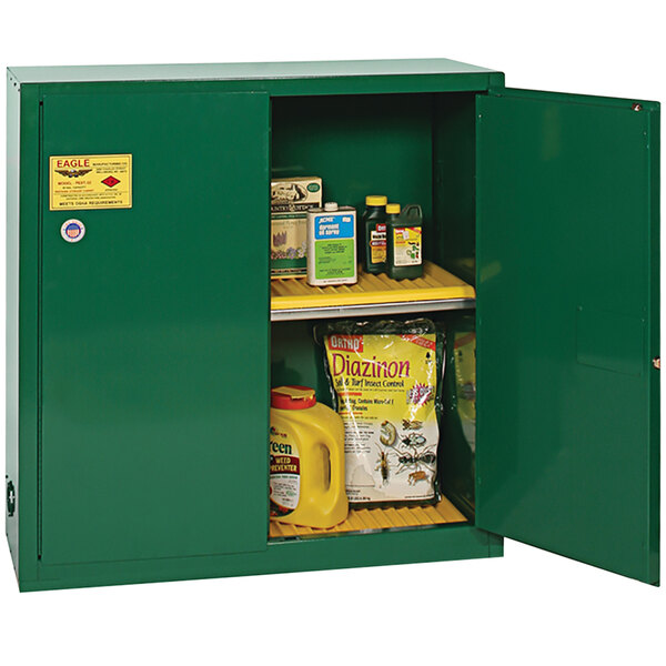 An Eagle Manufacturing green metal pesticide safety cabinet with shelves and doors.
