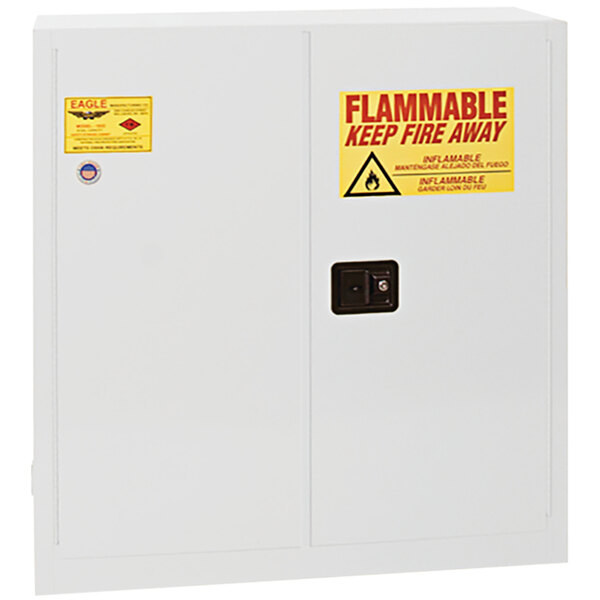 A white Eagle Manufacturing safety cabinet with a yellow flammable sign.