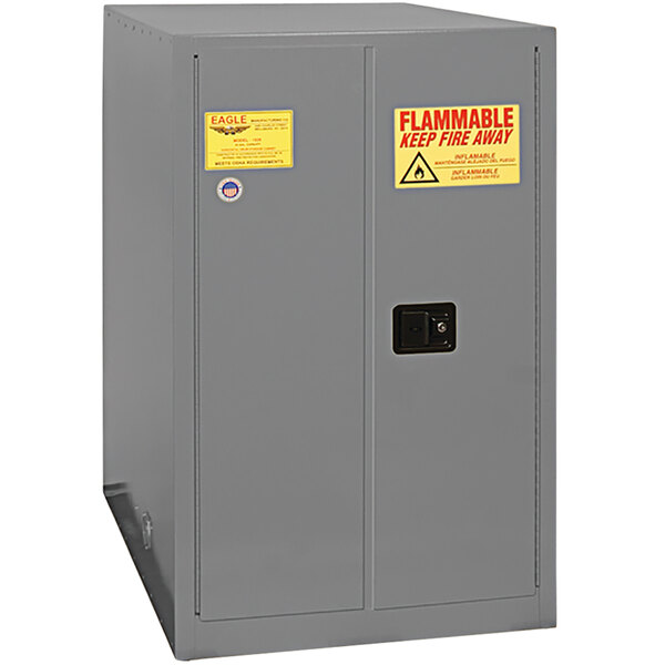 An Eagle gray metal safety cabinet with a yellow and red warning label.