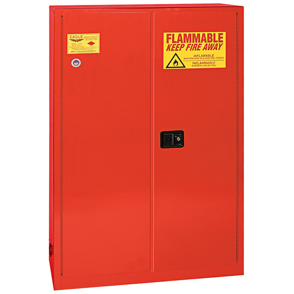 A red metal Eagle Manufacturing safety cabinet with yellow warning signs.