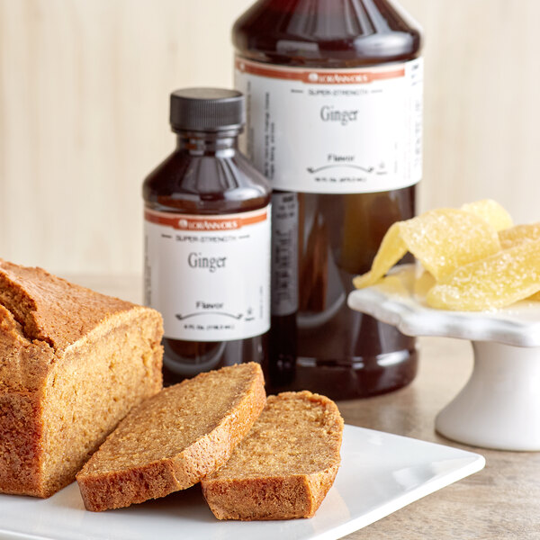 A loaf of bread and a bottle of LorAnn Oils Ginger Super Strength Flavor on a plate.