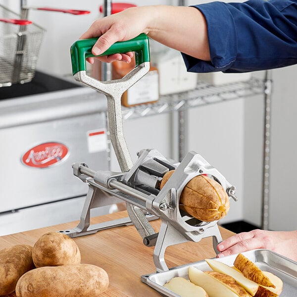 A person using a Garde Heavy-Duty Potato Wedge Cutter to cut potatoes.