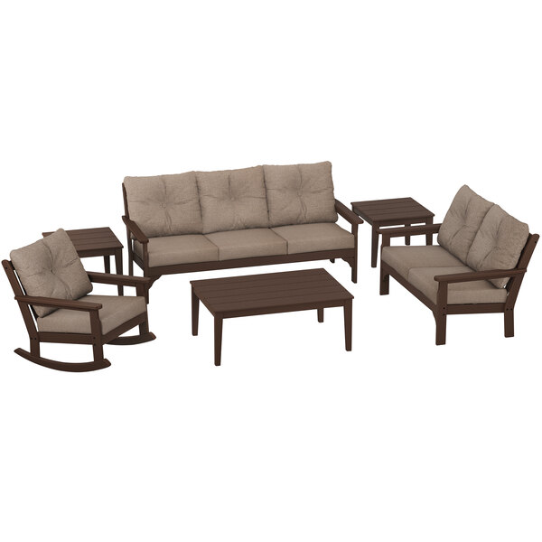 A POLYWOOD mahogany and burlap outdoor seating set with a table, sofa, rocking chair, and beige cushions.