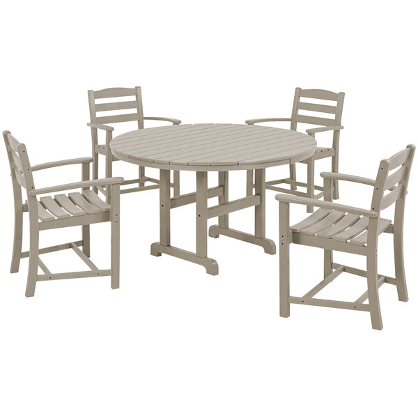 A POLYWOOD round dining table and 4 arm chairs with a white round top.