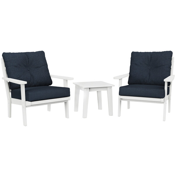 Two white Lakeside chairs and a table with blue cushions.
