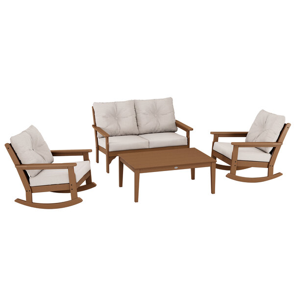 A group of POLYWOOD outdoor furniture with a coffee table, a white rocking chair, and two white chairs.