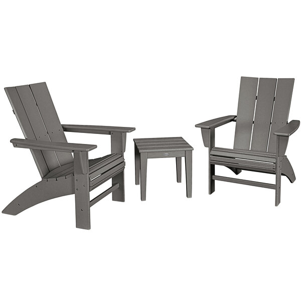 A group of three grey POLYWOOD curveback Adirondack chairs and a table.
