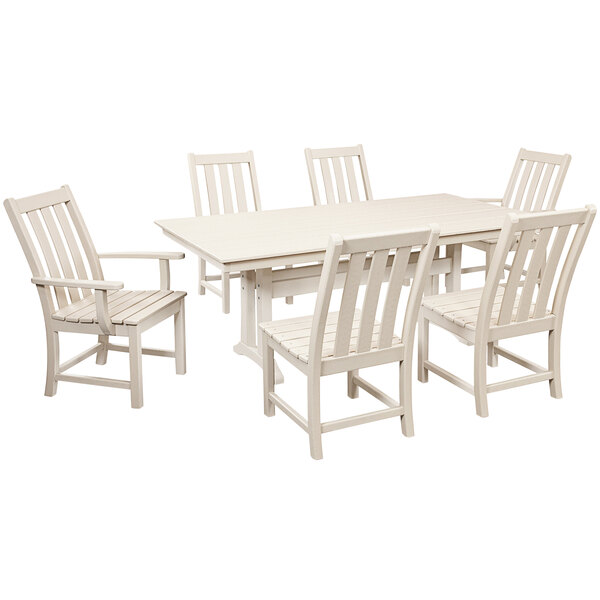 A white POLYWOOD dining table with a white background and six white chairs.