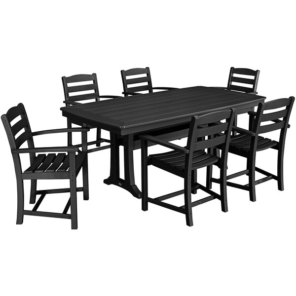 A black POLYWOOD outdoor dining table with six arm chairs and a Nautical trestle table.