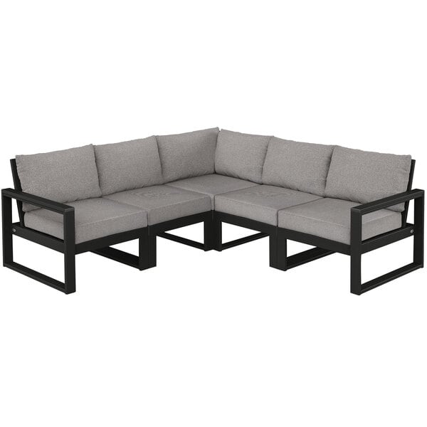 A black and grey POLYWOOD sectional couch with cushions.