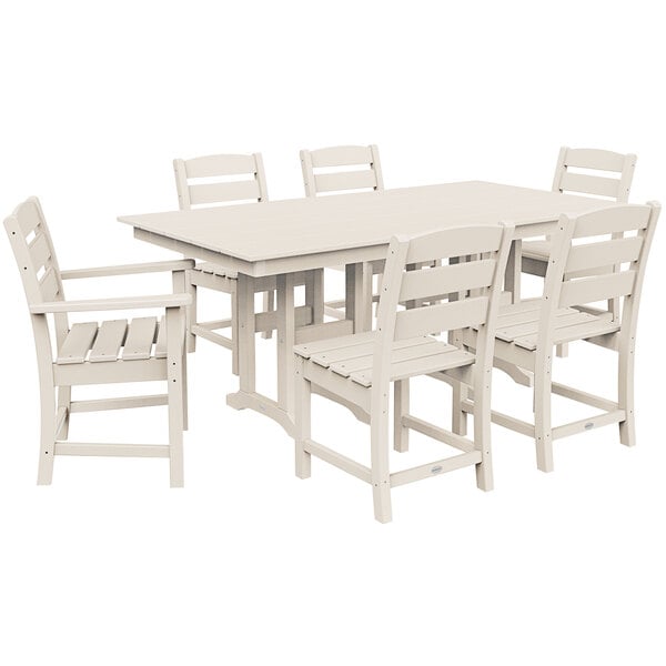 A POLYWOOD white farmhouse table and chairs on an outdoor patio.