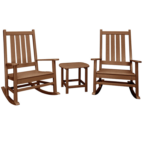A brown POLYWOOD wooden rocking chair with armrests next to a wooden table.