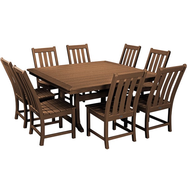 A POLYWOOD teak dining table and chairs around each other.