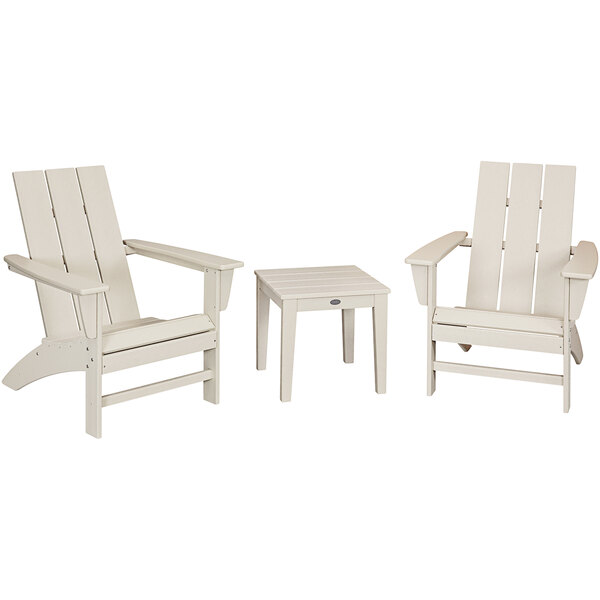 A group of white POLYWOOD Adirondack chairs with a table.