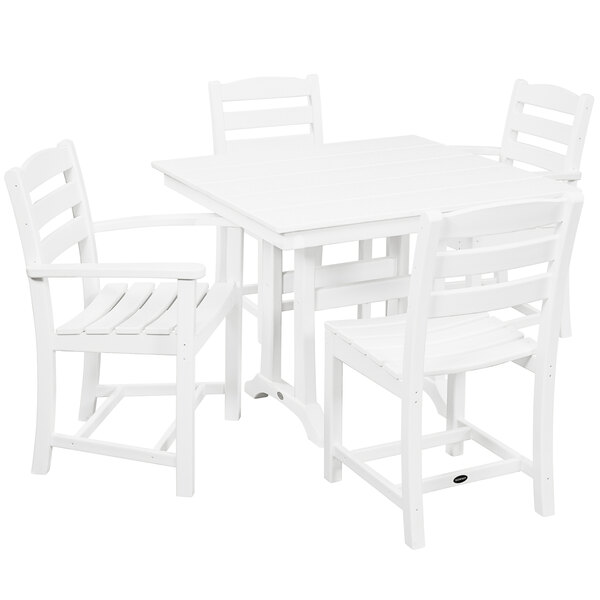 A white POLYWOOD farmhouse dining table and four chairs.
