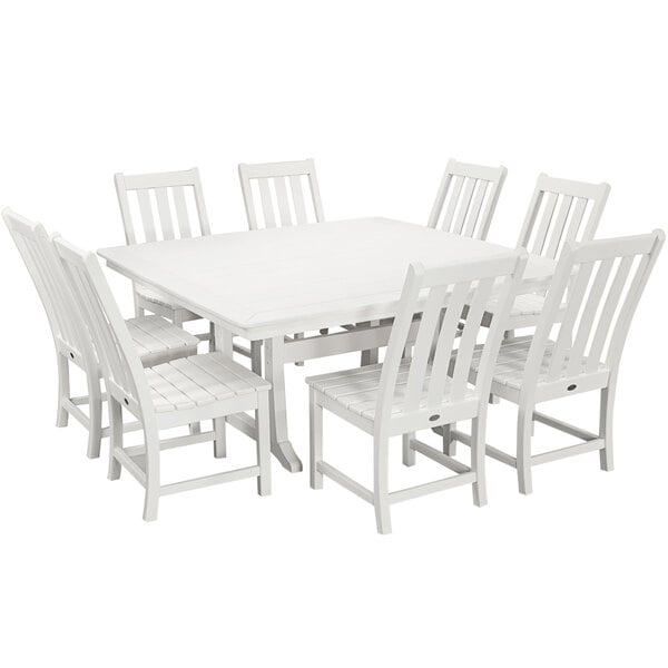 A white POLYWOOD dining table and chairs with a white chair at the table.