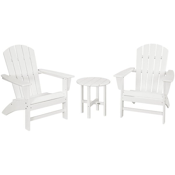 A group of three white POLYWOOD Nautical Adirondack chairs and a round table.