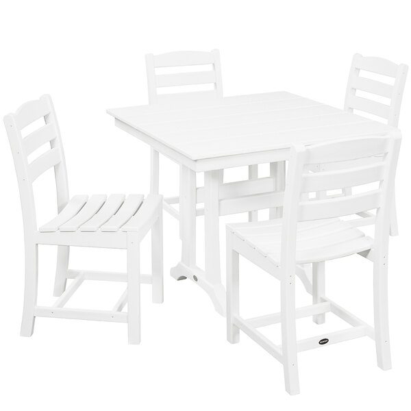 A POLYWOOD white farmhouse table with four white chairs.
