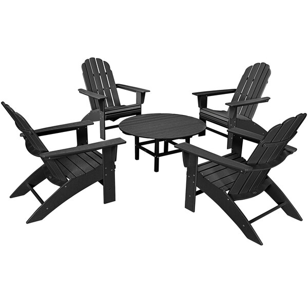 A POLYWOOD black patio table with four black Curveback Adirondack chairs.