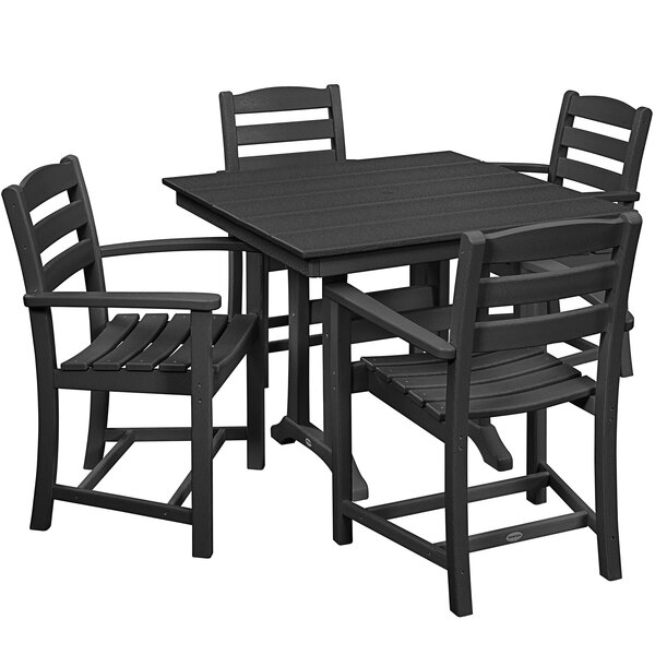 A POLYWOOD black farmhouse table with four armchairs.