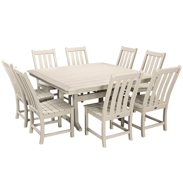 A white POLYWOOD dining table with a white surface and white chairs around it.