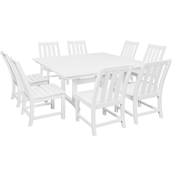 A close-up of a white POLYWOOD dining table with chairs around it.